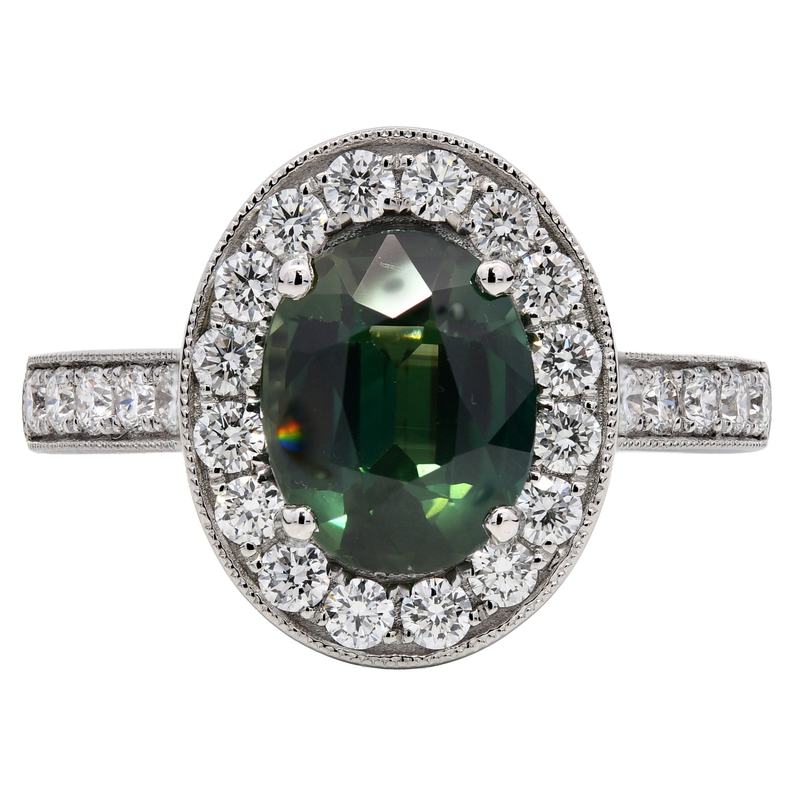 3.28ct teal sapphire & diamond engagement ring, oval cut set in a platinum halo. WGI certified