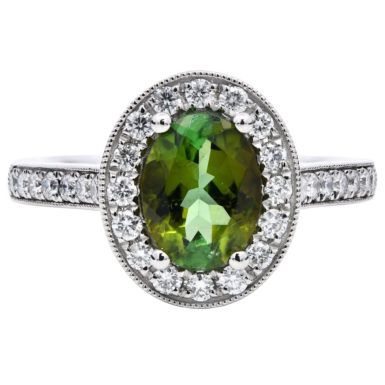 1.58ct green tourmaline & diamond engagement ring, oval cut set in a platinum halo. WGI certified